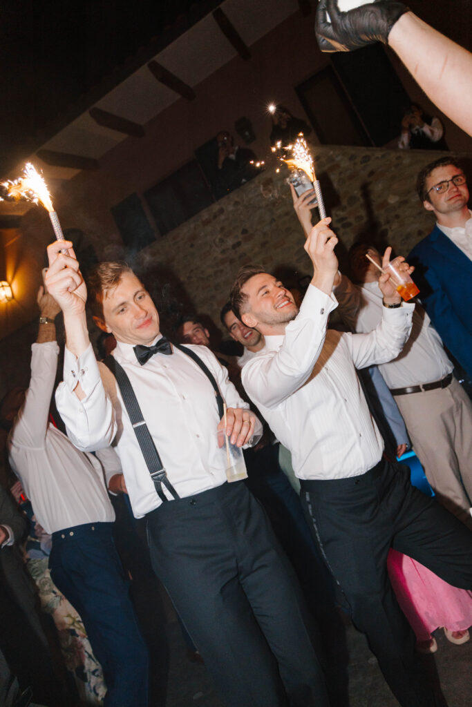 grooms hold sparklers and dance at wedding reception taken by destination wedding photographer