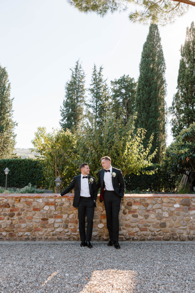 grooms look at each other at italian wedding taken by traveling wedding photographer