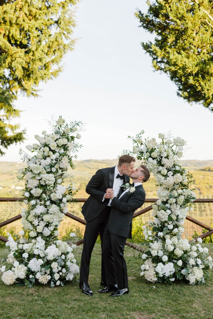 grooms kiss at wedding ceremony in italy taken by destination wedding photographer
