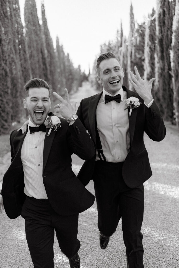 grooms show off rings in black and white photo celebrating their marriage