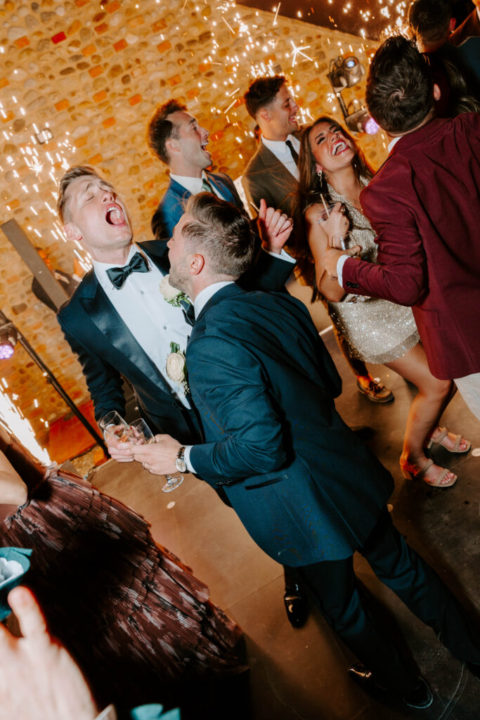 grooms dance at wedding reception celebrating their marriage in italy