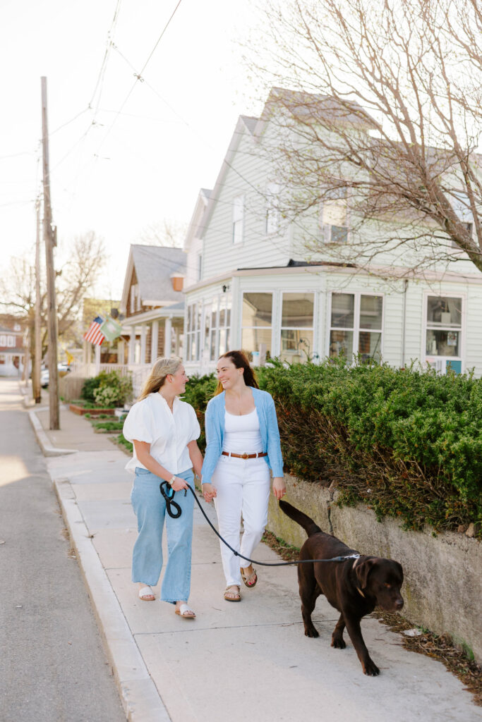 Couple walking dog together on East Boston neighborhood street
