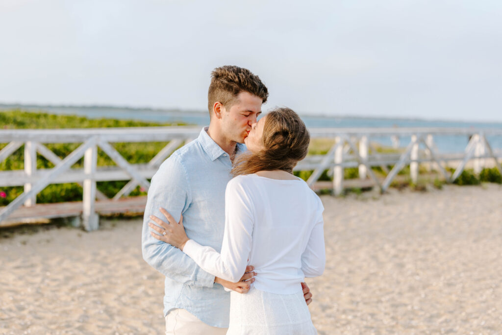 boy and girl kiss on cape cod beach