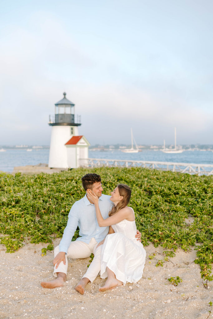 man and woman look at each other with brant lighthouse in nantucket