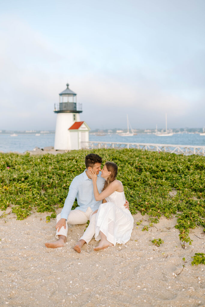 woman and man kiss with brant point lighthouse in background