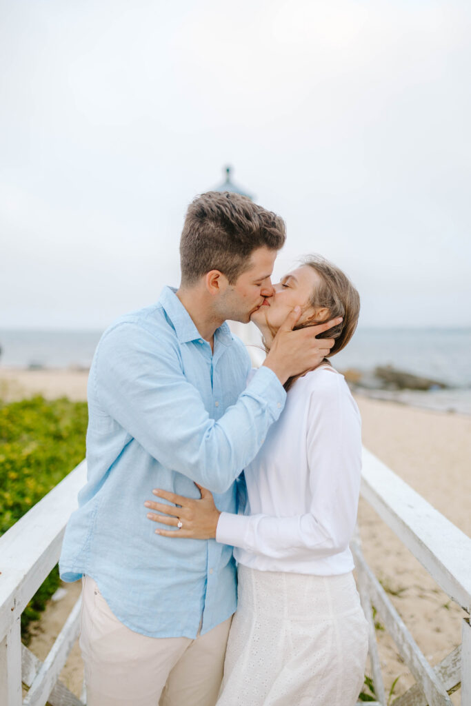 man and woman kiss on beach taken by nantucket wedding photographer