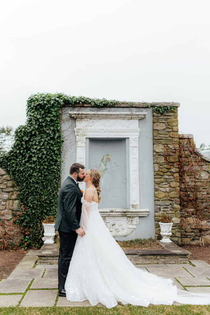 bride and groom share first kiss at Shepherd’s Run in Rhode Island