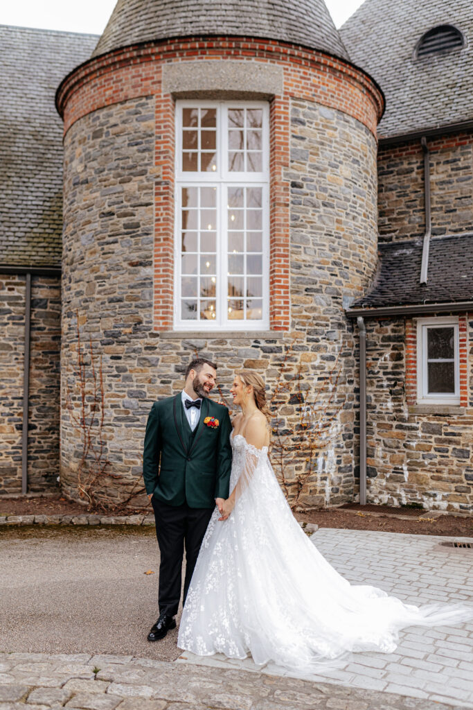 bride and groom smile at each other in front of Shepherd’s Run wedding venue