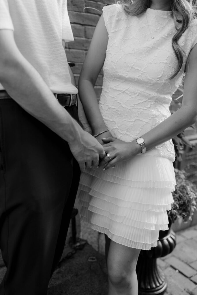 Close up black and white engagement photo of Margaret and Chris holding hands in Beacon Hill Boston