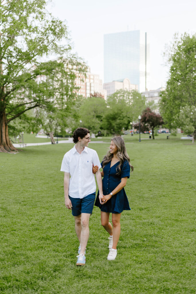 Couple walking together in Boston Common during sunset engagement photos