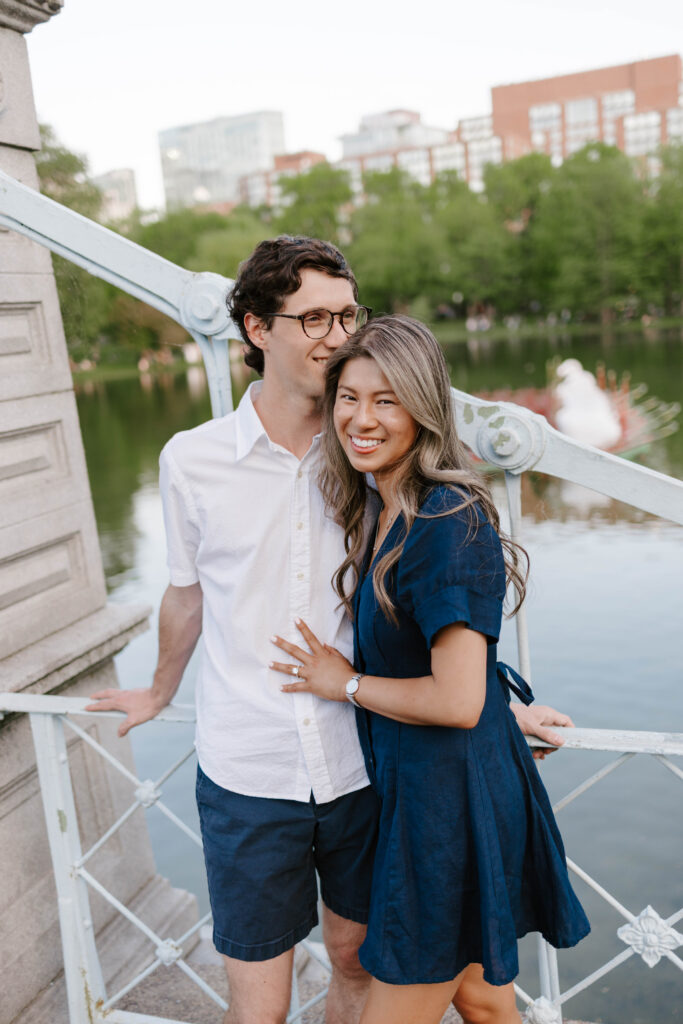 Couple posing on a bridge in Boston Common during engagement session
