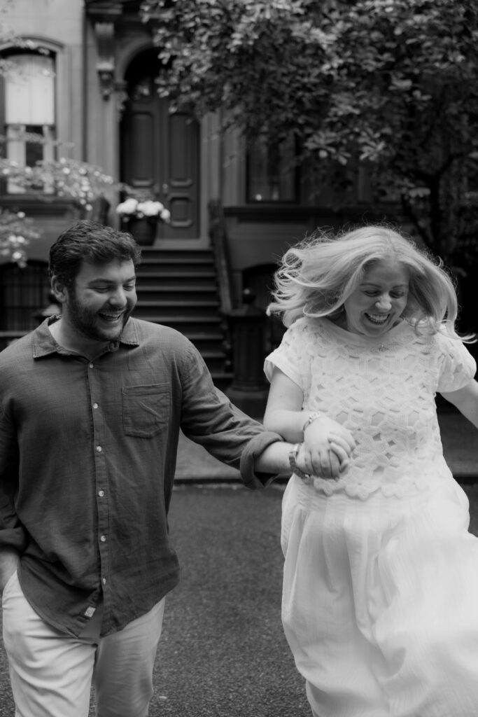 Close up black and white candid engagement portrait during rainy NYC session. Photo by Clay Taylor Photo