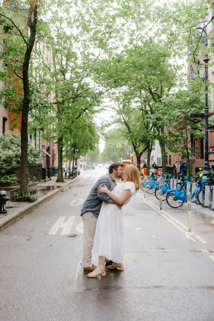 Couple dipping in West Village streets lined with brownstones in Manhattan. Photo by Clay Taylor Photo