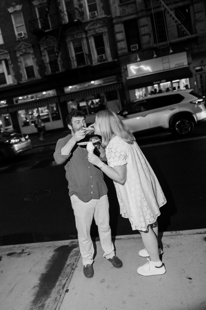 Black and white candid engagement photo eating pizza and ice cream in Manhattan. Photo by Clay Taylor Photo
