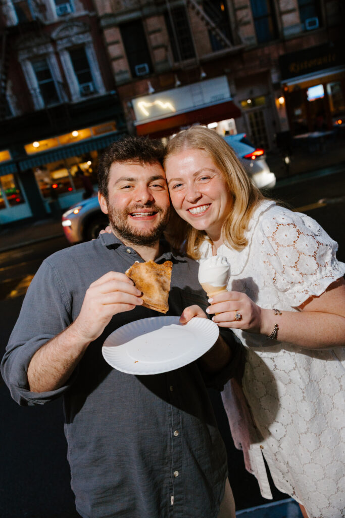 Couple smiling with pizza and ice cream during downtown Manhattan engagement session. Photo by Clay Taylor Photo