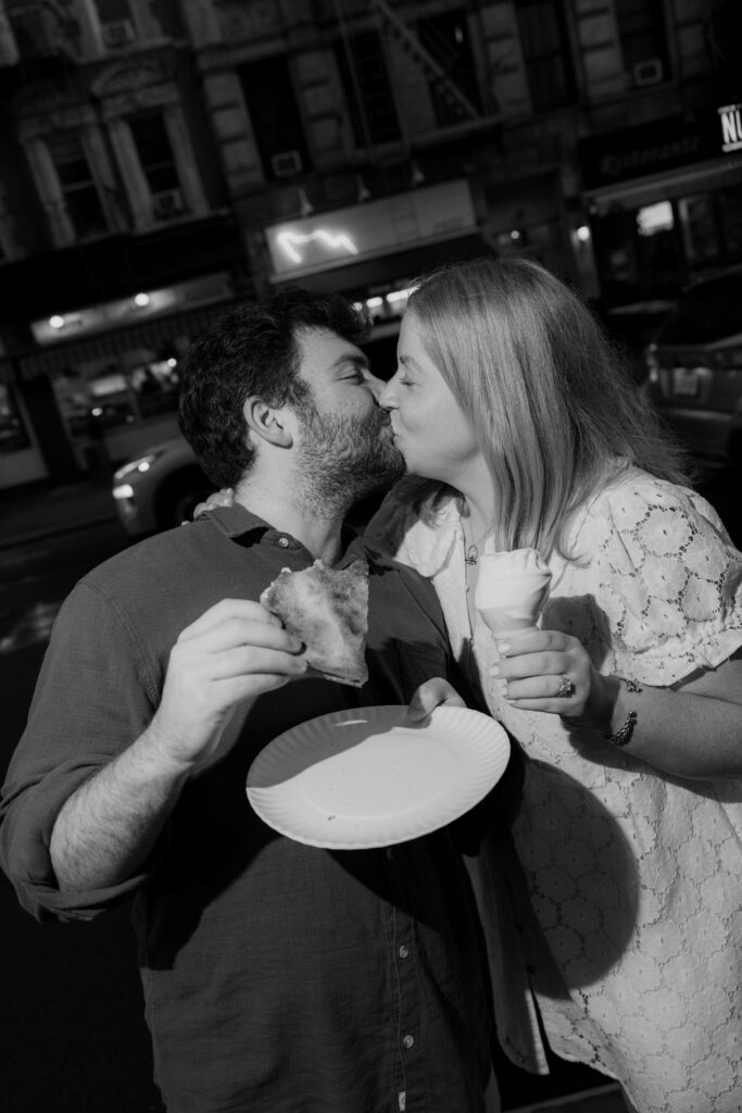 Romantic black and white engagement portrait sharing pizza and ice cream in New York City. Photo by Clay Taylor Photo