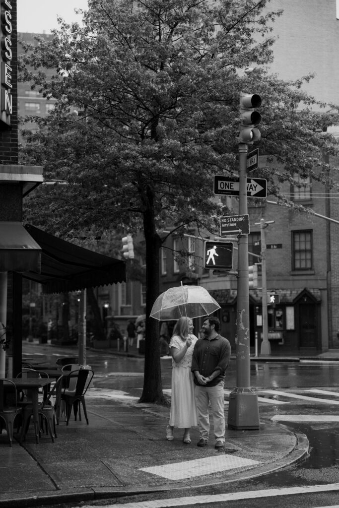 Black and white rainy engagement portrait in the West Village of Manhattan. Photo by Clay Taylor Photo