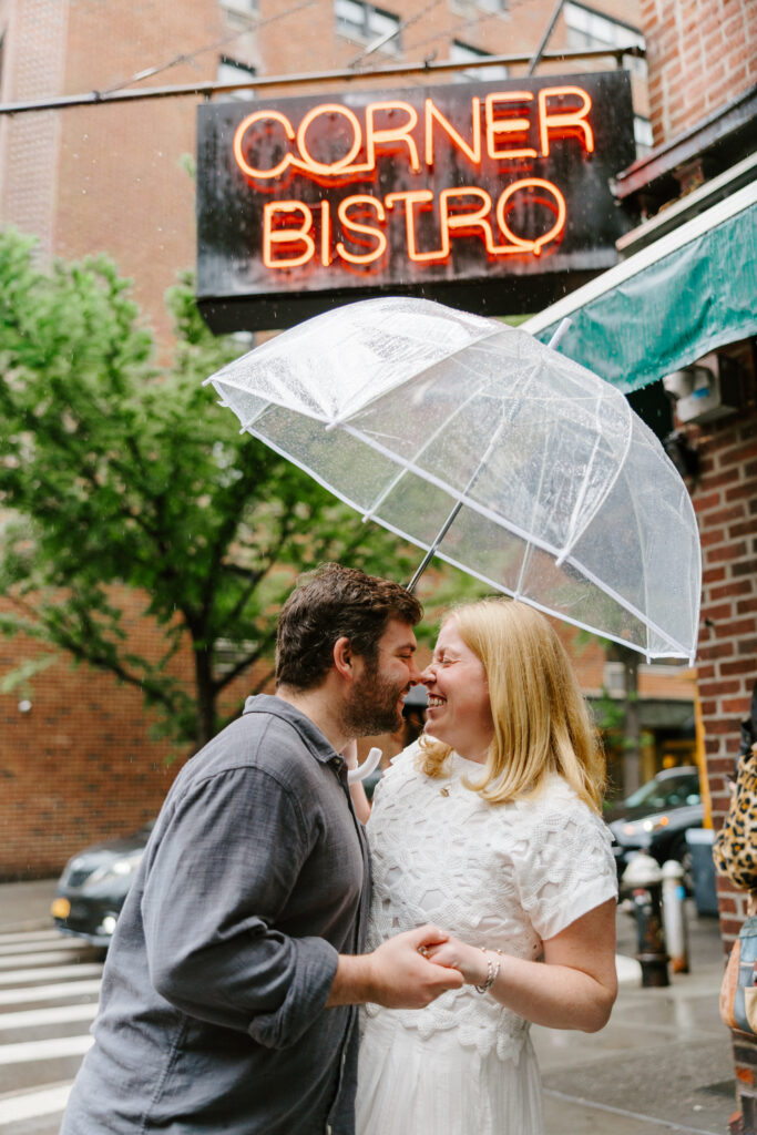 Romantic umbrella engagement portraits outside Corner Bistro in New York City. Photo by Clay Taylor Photo