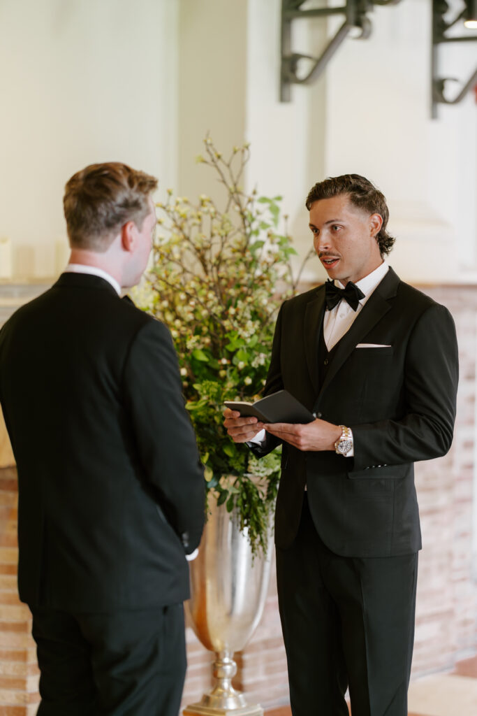 Spencer reading emotional vows during their wedding ceremony at the Boston Public Library.