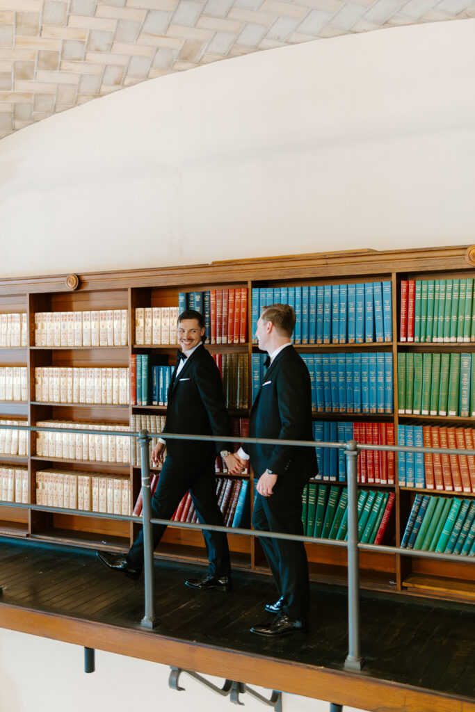 Ryan and Spencer walking together through the historic library stacks at the Boston Public Library in Boston.