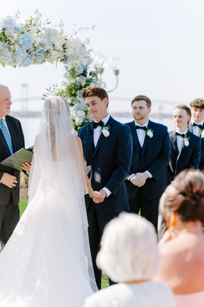 Groom looking at bride at ceremony at Belle Mer