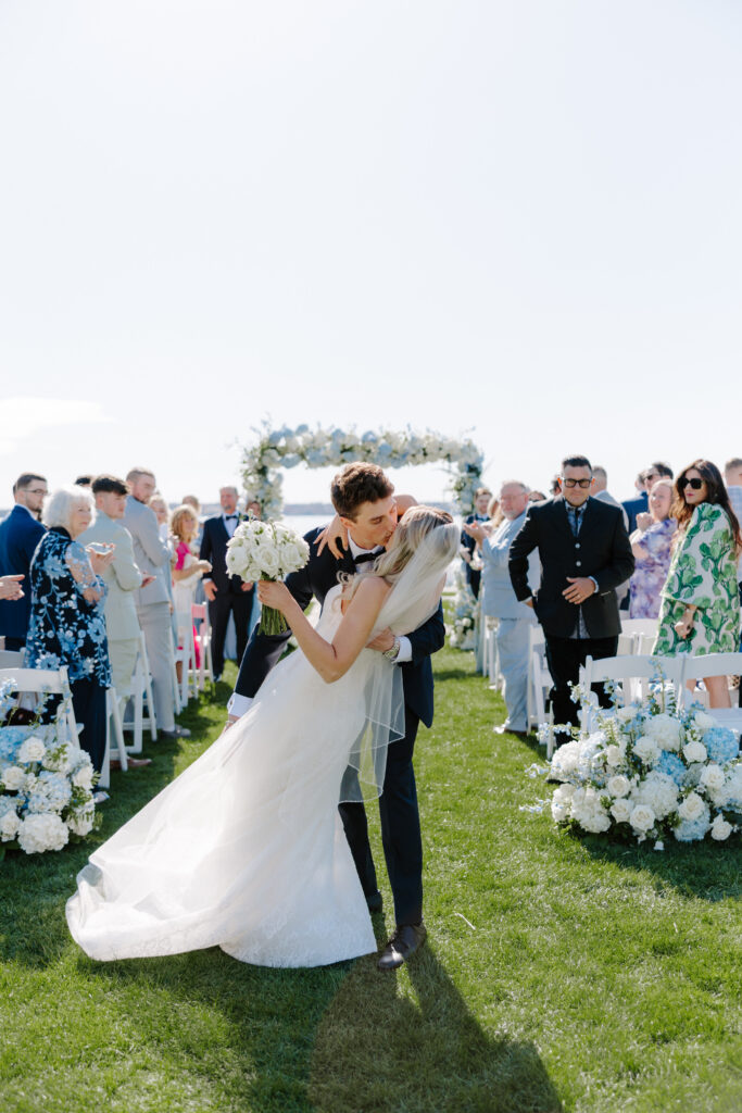 Groom dips bride at the end of aisle at wedding ceremony in Rhode Island