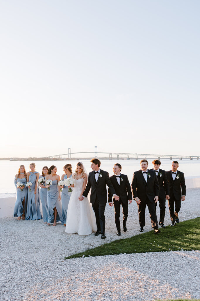 Wedding party photo on the water with the Claiborne Pell Newport bridge in the background