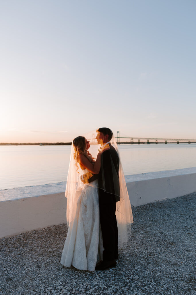 Sunset portrait of bride and groom looking at each other aat Belle Mer
