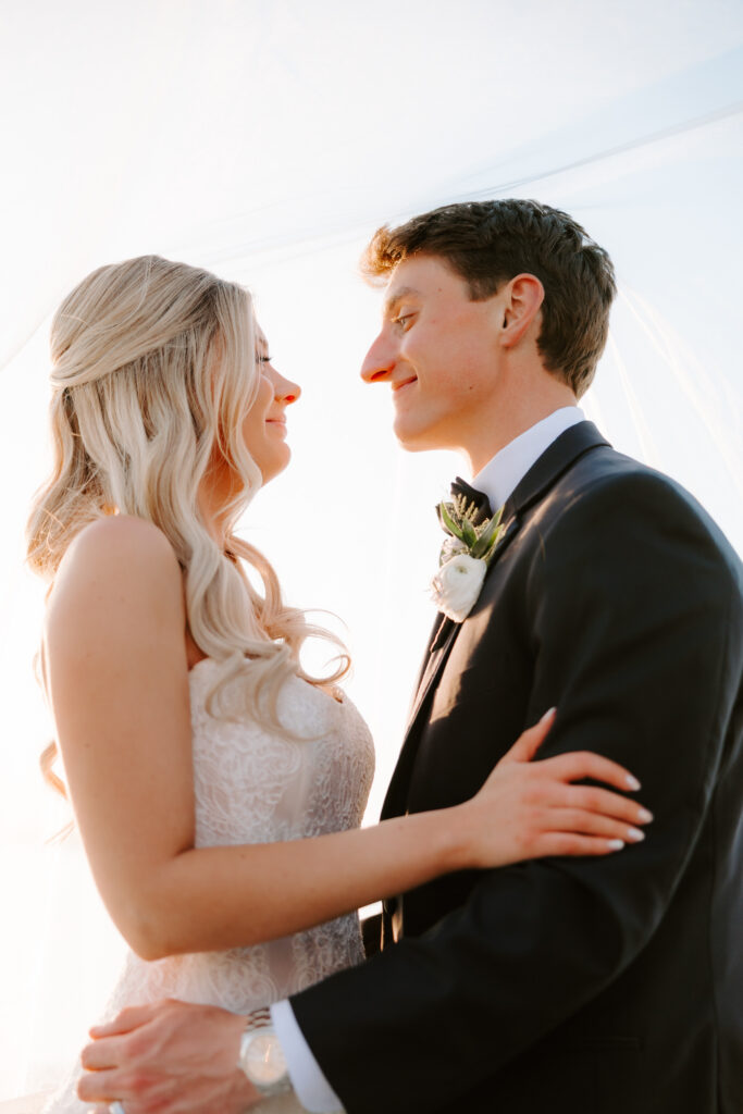 Sunset portrait of bride and groom staring at each other in Rhode Island