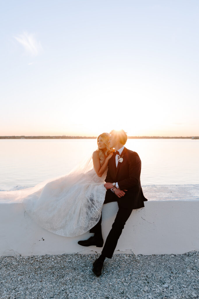 Golden hour sunset portrait of bride and groom at Belle Mer