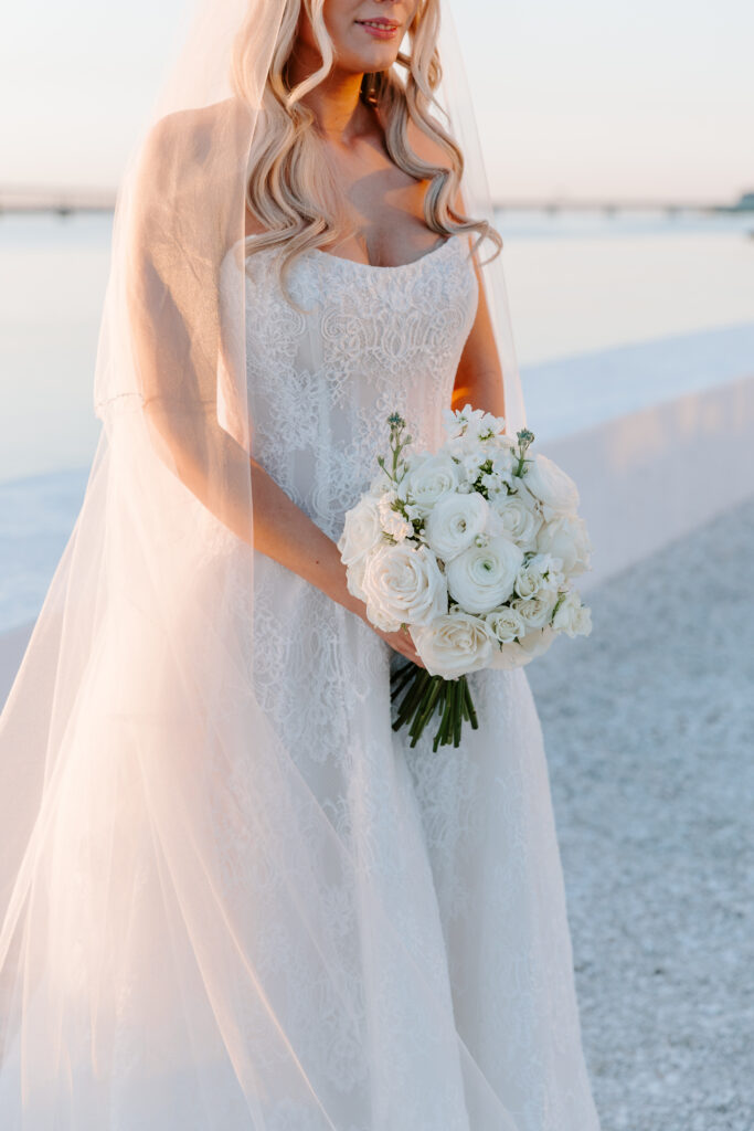 Detail photo of bride holding bouquet taken by Clay Taylor Photo