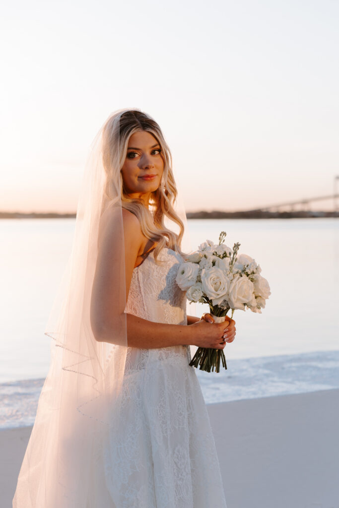 Bridal portrait of bride holding bouquet at sunset in Newport
