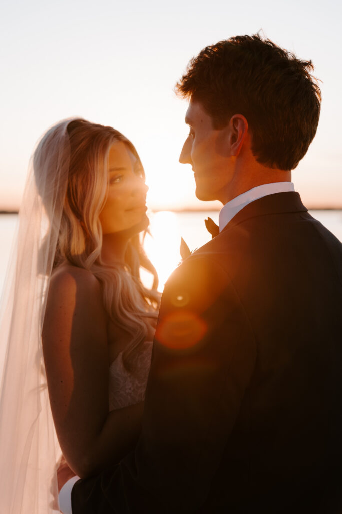 Sunset portrait of bride looking at groom at summer Newport wedding