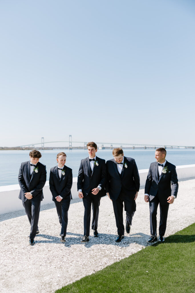 Groomsmen portrait of groomsmen walking at Belle Mer