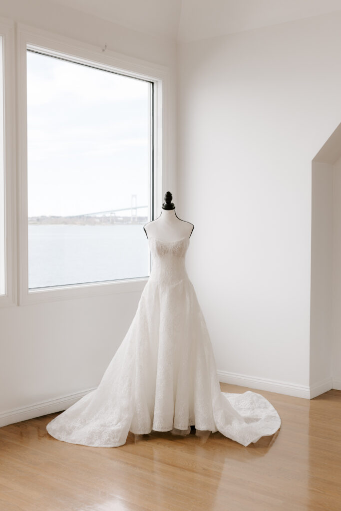 Detail photo of wedding dress with the Claiborne Pell Newport Bridge in the background