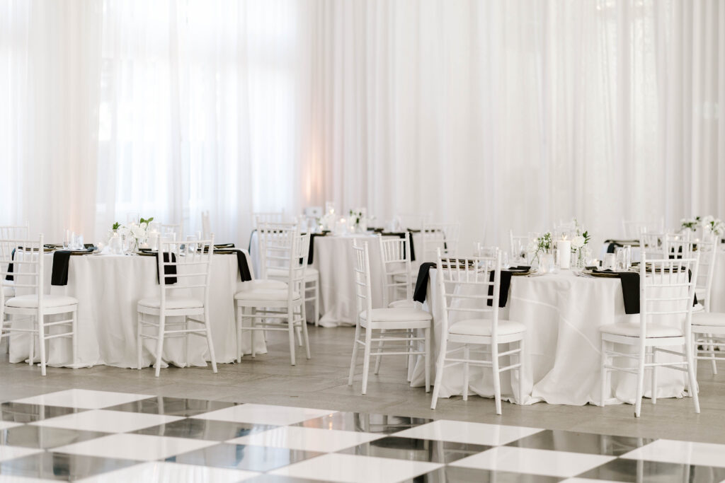 Detail photo of reception space with black and white decor and checkered dance floor at Belle Mer