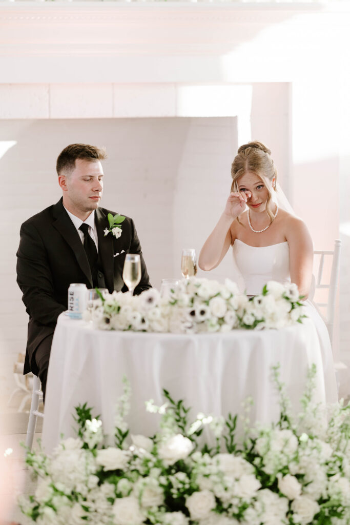 Bride sheds tear during speech at wedding reception in Newport, Rhode Island