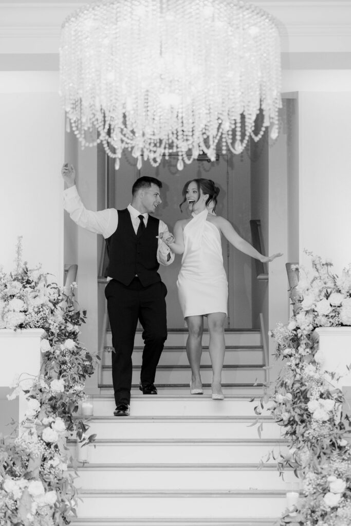 Black and white photo of bride and groom grand entrance at reception taken by Clay Taylor Photo