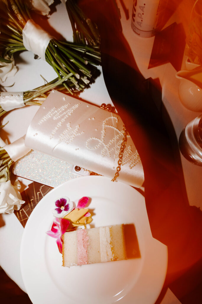 Detail photo of brides purse and groom tie on table
