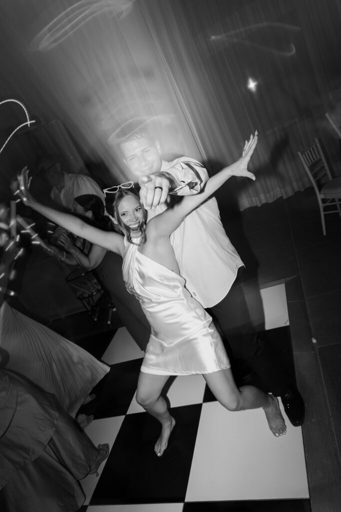 Bride and groom black and white photo dancing at wedding reception