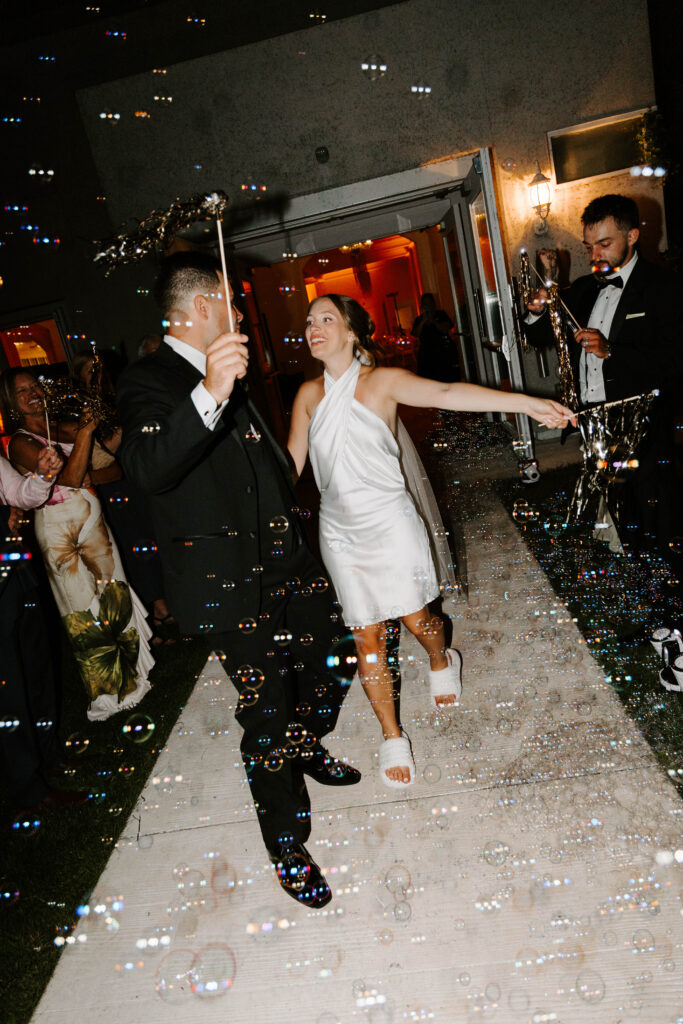 Bride and groom grand exit with bubbles 