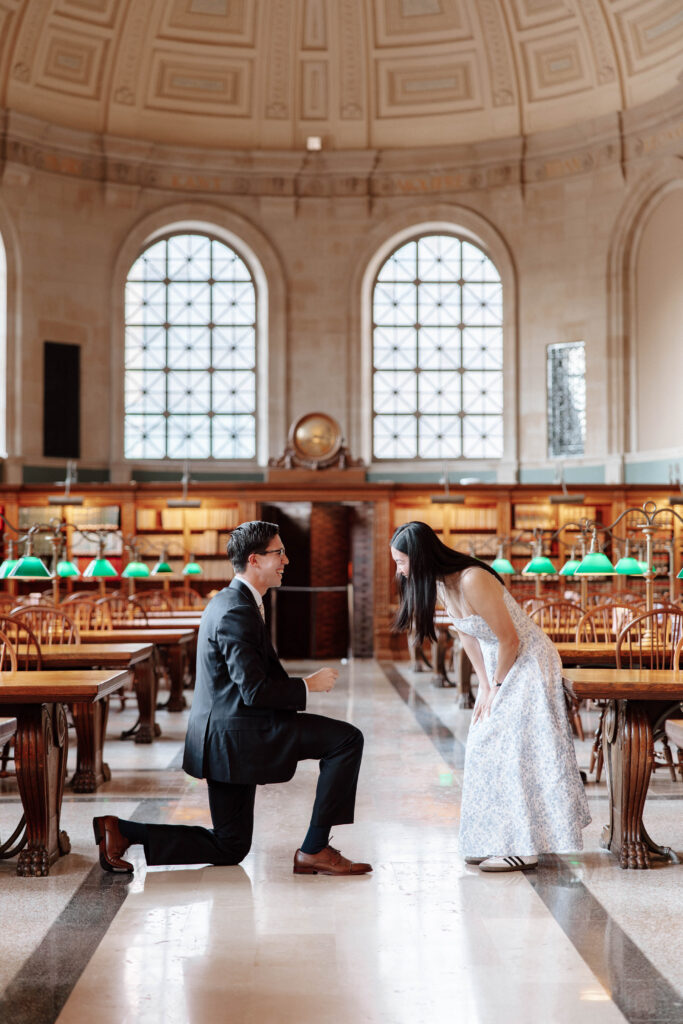 Man proposes to woman in Bates Hall at the Boston Public Library