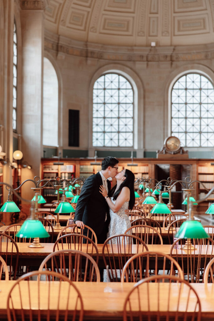 Man and woman kiss in Bates Hall at the Boston Public Library