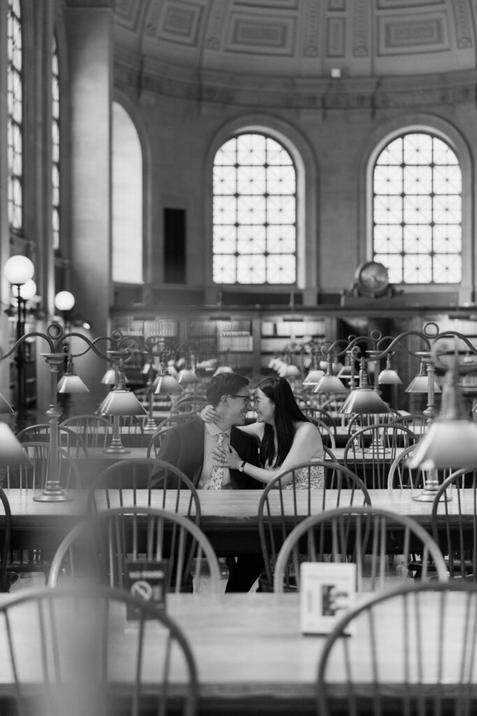 Man and woman celebrate proposal at the Boston Public Library
