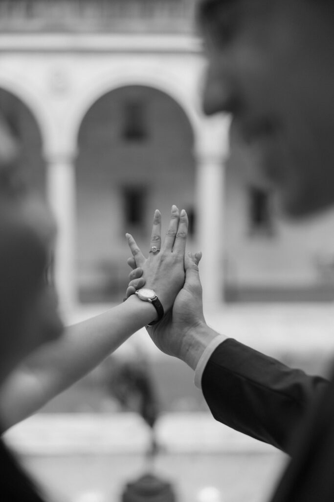 Black and white detail photo of woman's engagement ring at proposal in Boston