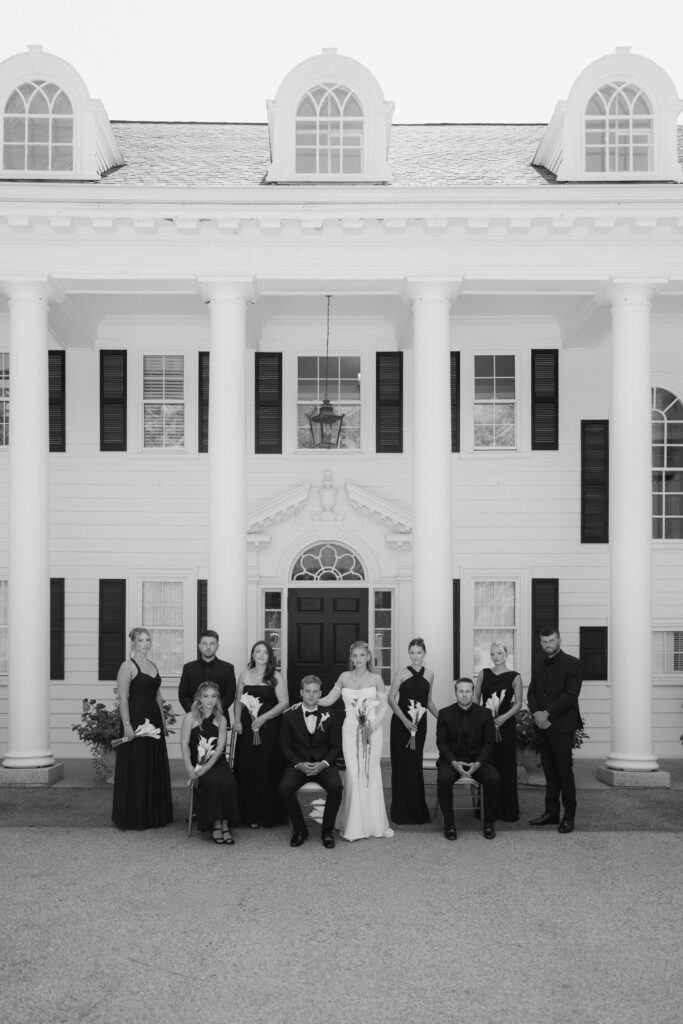 Editorial black and white wedding party photo in front of the Floriana wedding venue