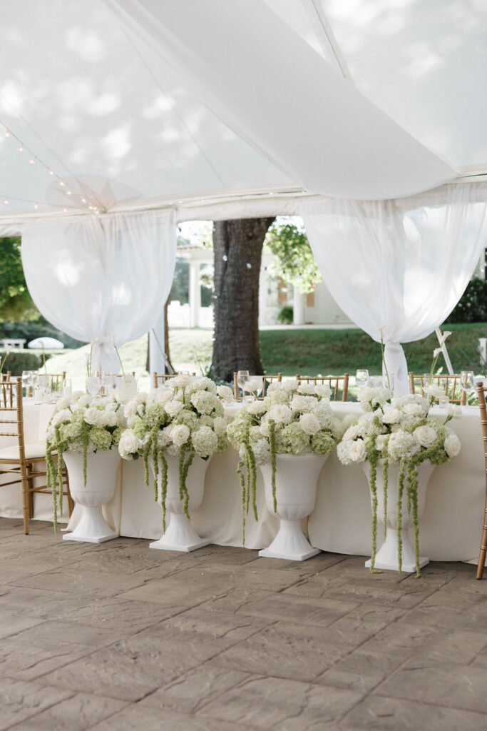 Floral arrangements inside tented reception at the Floriana wedding venue