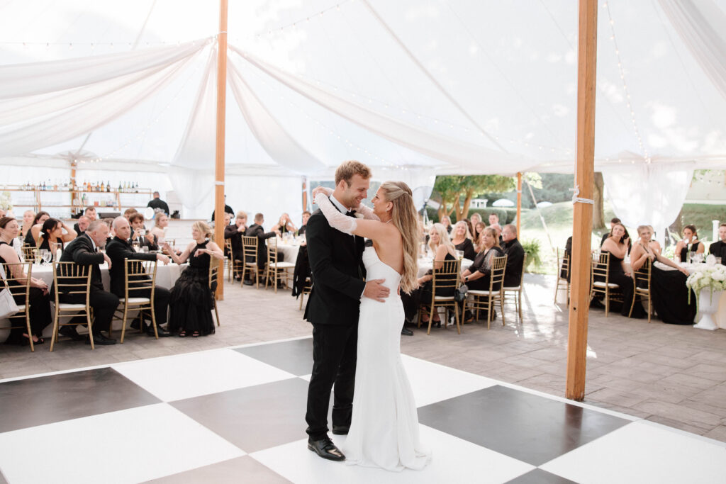 Couple shares first dance under tented reception in New England