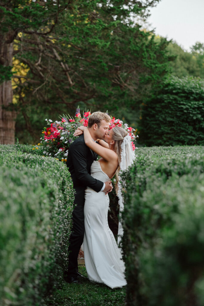 Groom kisses bride at the Floriana wedding venue in the garden