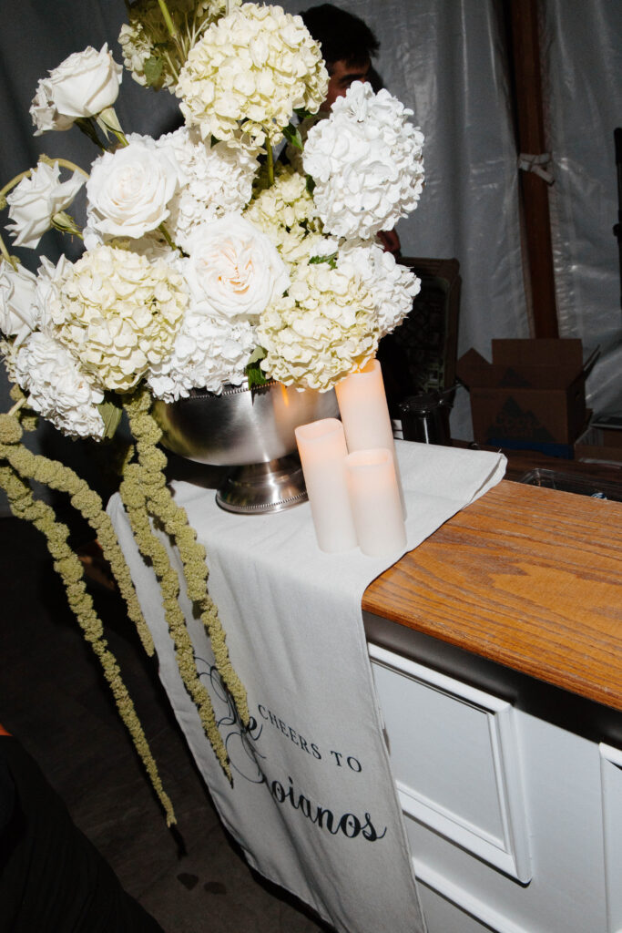 Detail flash photo of floral arrangement on bar at reception